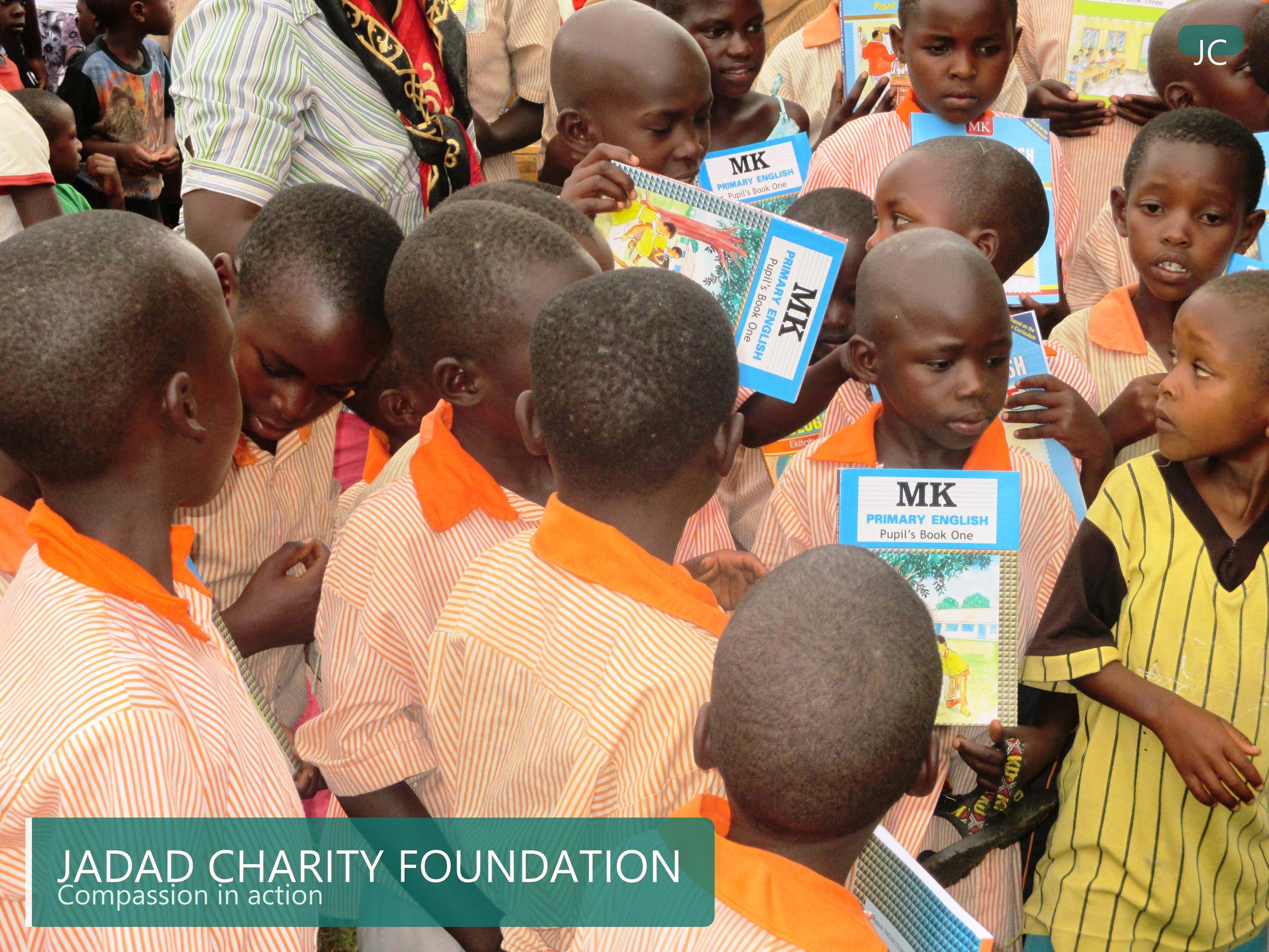 Ugandan school children receiving textbooks